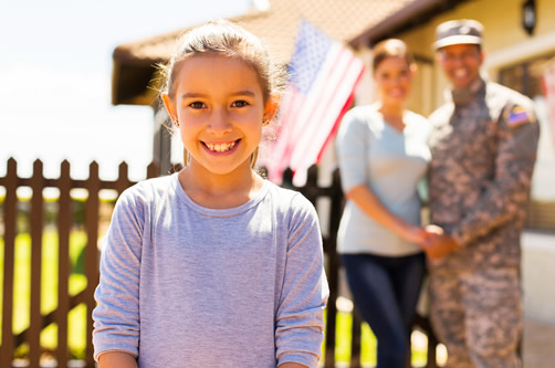 Military family in front of home